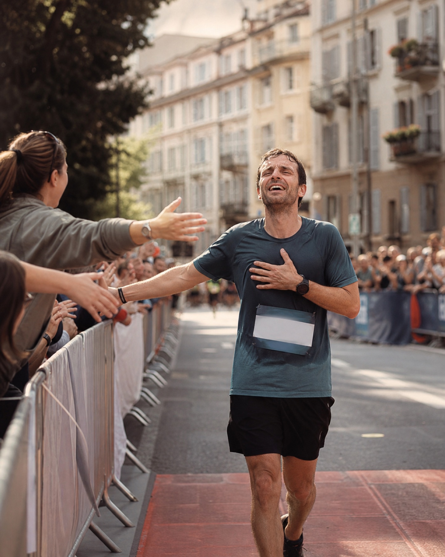 A runner overwhelmed with joy at a marathon finish